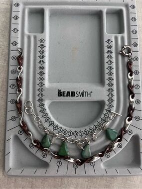 Silver bracelet and necklace with accents.
